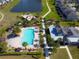 Aerial view of community pool, splashpad, playground, cabanas, and clubhouse at 5023 Southlawn Ave, Orlando, FL 32811