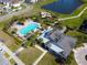 Aerial view of community pool, splashpad, playground, cabanas, and clubhouse at 5023 Southlawn Ave, Orlando, FL 32811