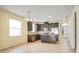 Well-lit kitchen featuring dark cabinetry, stainless steel appliances, and a central island at 5023 Southlawn Ave, Orlando, FL 32811