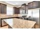 Granite countertops, stainless steel appliances, and dark cabinets highlight the kitchen at 5023 Southlawn Ave, Orlando, FL 32811