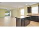 Open floor plan with tile flooring connecting the kitchen and living area with slider doors at 5023 Southlawn Ave, Orlando, FL 32811