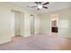 Expansive main bedroom with two entry doors, ceiling fan, and ensuite bathroom access at 5023 Southlawn Ave, Orlando, FL 32811