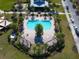 Aerial view of a beautiful community pool with lounge chairs, palm trees, and shaded areas at 5023 Southlawn Ave, Orlando, FL 32811