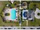 Aerial view of a community pool, lounge area and clubhouse with manicured landscaping at 5023 Southlawn Ave, Orlando, FL 32811