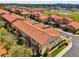 Aerial view of a residential community featuring multiple homes with red tile roofs and manicured landscaping at 5150 Fiorella Ln, Sanford, FL 32771