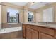 Bathroom featuring double vanity sinks, a soaking tub, and lots of natural light at 5150 Fiorella Ln, Sanford, FL 32771