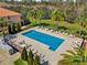 Aerial view of a large community swimming pool with lounge chairs and manicured landscaping at 5150 Fiorella Ln, Sanford, FL 32771