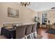 Cozy dining room with a black tablecloth, hardwood floors, a modern chandelier, and a large window at 5150 Fiorella Ln, Sanford, FL 32771