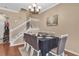 Elegant dining room with a formal table set for six, featuring a staircase and neutral color scheme at 5150 Fiorella Ln, Sanford, FL 32771