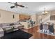 Bright, open living room with modern ceiling fan flowing into the dining room and an adjacent breakfast bar at 5150 Fiorella Ln, Sanford, FL 32771