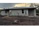 Unfinished block home featuring a new roof and modern windows, awaiting its final touches at 5238 2Nd St, Orlando, FL 32810