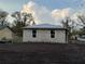 Unfinished block home featuring new roof and modern windows, set on a level lot, awaiting finishing touches at 5238 2Nd St, Orlando, FL 32810