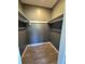 Walk-in closet provides ample storage with wood-look floors and neutral color scheme at 5505 Hernandes Dr # 125, Orlando, FL 32808