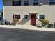 Condominium exterior with burgundy shutters and front door, clean landscaping, and gray parking area at 5505 Hernandes Dr # 125, Orlando, FL 32808