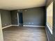 Spacious living room with modern wood flooring and neutral gray walls at 5505 Hernandes Dr # 125, Orlando, FL 32808