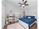 Cozy bedroom features a ceiling fan, a desk area, and a comfortable bed at 629 Nighthawk Cir, Winter Springs, FL 32708