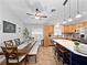 Kitchen features a center island with bar stool seating, dining table with bench, and wooden cabinetry at 629 Nighthawk Cir, Winter Springs, FL 32708