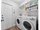 Functional laundry room with a washer, dryer, and built-in shelving for storage at 629 Nighthawk Cir, Winter Springs, FL 32708