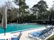 Community pool with blue lounge chairs and umbrellas for residents and their guests at 629 Nighthawk Cir, Winter Springs, FL 32708