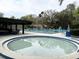 Community pool with an adjacent hot tub and tables with chairs at 629 Nighthawk Cir, Winter Springs, FL 32708