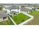 Aerial view of a fenced backyard and a covered patio, and solar panels on the roof at 630 Citrus Isle Blvd, Davenport, FL 33837