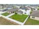 Areal view of the backyard featuring a well-maintained lawn, white fence, and solar panels on the roof at 630 Citrus Isle Blvd, Davenport, FL 33837