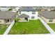 Aerial view of a spacious, fenced backyard with a covered patio and green lawn at 630 Citrus Isle Blvd, Davenport, FL 33837