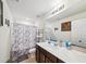 Bathroom featuring a marble shower curtain, a dark wood vanity, and a single sink at 630 Citrus Isle Blvd, Davenport, FL 33837