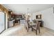 Open dining room featuring tile floors, modern light fixtures, and a breakfast bar looking into the kitchen at 630 Citrus Isle Blvd, Davenport, FL 33837