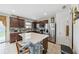 Kitchen with stainless steel appliances, center island with mosaic tile, and dark wood cabinetry at 630 Citrus Isle Blvd, Davenport, FL 33837