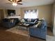 Cozy living room featuring comfortable sofas, a fireplace, and a large window at 6630 Abeydon Ct, Orlando, FL 32818