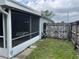 Private backyard with a screened lanai and access gate at 636 Bohannon Blvd, Orlando, FL 32824