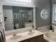 Bright bathroom with double sink vanity, soaking tub, glass shower and large mirror at 636 Bohannon Blvd, Orlando, FL 32824