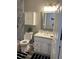 Well-lit bathroom featuring a tiled shower, modern vanity, and stylish decor at 636 Bohannon Blvd, Orlando, FL 32824