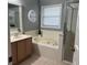 Bathroom featuring a soaking tub, separate shower, and neutral color scheme at 636 Bohannon Blvd, Orlando, FL 32824