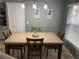 Dining area with a wooden table, chairs, and modern lighting at 636 Bohannon Blvd, Orlando, FL 32824