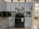 Well-lit kitchen features gray cabinets, granite countertops, and stainless steel range at 636 Bohannon Blvd, Orlando, FL 32824