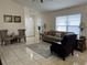 Inviting living room with tile floors, neutral tones, and a large window for ample natural light at 636 Bohannon Blvd, Orlando, FL 32824