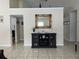 Open-concept living space with tiled floors, a decorative mirror, and modern furnishings at 636 Bohannon Blvd, Orlando, FL 32824