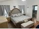 Comfortable bedroom featuring a large bed with neutral bedding and ensuite bathroom access at 636 Bohannon Blvd, Orlando, FL 32824