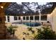 A screened in pool with stone surrounding, plants, and string lights adds character to the backyard at 1035 Northern Way # 171, Winter Springs, FL 32708