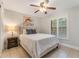 Comfortable bedroom with a neutral color scheme, ceiling fan, and natural light from the window at 1055 Kensington Park Dr # 111, Altamonte Springs, FL 32714