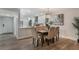 Cozy dining area with seating for six and a modern chandelier, open to the kitchen at 1055 Kensington Park Dr # 111, Altamonte Springs, FL 32714