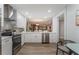 Modern, renovated kitchen featuring stainless steel appliances, white cabinets, and stylish flooring at 1055 Kensington Park Dr # 111, Altamonte Springs, FL 32714