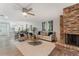Bright living room featuring a brick fireplace, plush seating, and an open layout to the dining area at 1055 Kensington Park Dr # 111, Altamonte Springs, FL 32714