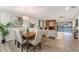 Open concept dining and living room with elegant decor, modern lighting, and wood-look flooring at 1055 Kensington Park Dr # 111, Altamonte Springs, FL 32714