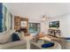Inviting living room with a cozy brick fireplace and sliding glass doors to the outdoor balcony at 1055 Kensington Park Dr # 111, Altamonte Springs, FL 32714
