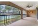 Relaxing screened patio with ceiling fan overlooking the tennis court and lush landscaping at 1055 Kensington Park Dr # 111, Altamonte Springs, FL 32714
