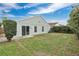 Exterior view of the backyard featuring a sliding glass door and partial fencing at 11223 Huxley Ave, Orlando, FL 32837