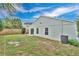 Exterior view of the backyard featuring a sliding glass door and partial fencing at 11223 Huxley Ave, Orlando, FL 32837